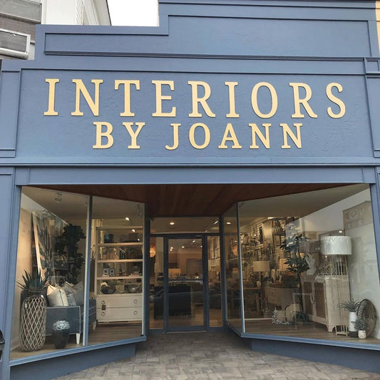 Gold dimensional acrylic letters mounted directly on the exterior facade above a retail storefront